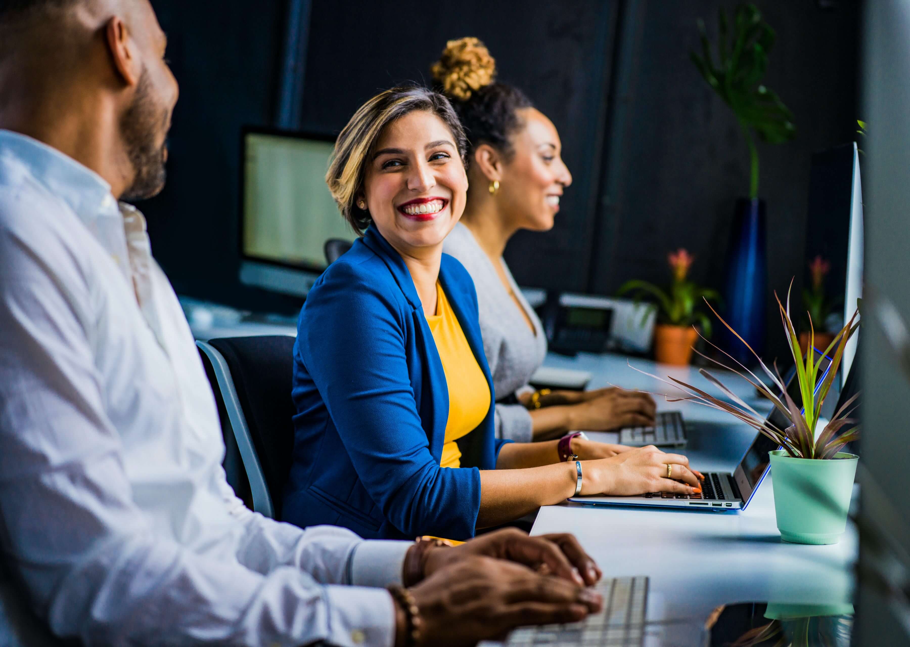 Smiling woman working with colleagues